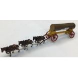 A 1950's diecast model of a horse drawn log carrier, with three horses.