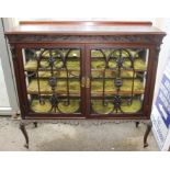 An Edwardian mahogany display cabinet, fitted with two glazed doors with decorative applied