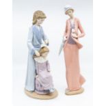 Two Nao figures of women, one is combing a girls hair