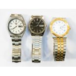 A collection of three gents Seiko watches to include a two tone SQ 100, white enamel dial, black