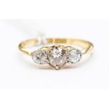 A three stone diamond 18ct gold ring, comprising old cut diamonds, with a total diamond weight