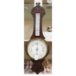 An early 20th Century oak banjo barometer and thermometer, carved case