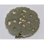 A Chinese jade carved disc pendant, possibly 19th Century, 5.5cms in diameter approx
