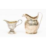 A George III silver helmet shaped cream jug, reeded rim, engraved with initials, London, 1815,