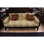 An Empire style mahogany three piece suite, comprising settee and a pair of bergere chairs, with