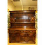 A George III style joined oak dresser and rack, traditionally hand crafted, the rack with two