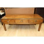 A late 20th Century yew veneered campaign style coffee table, fitted with three drawers, 47cm