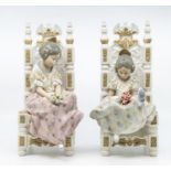 A pair of Lladro figures of young girls sitting on chairs