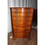 A Georgian style mahogany chest of drawers, early 20th Centruy, of serpentine form, comprising seven