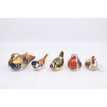 A collection of Royal Crown Derby paperweights to include garden birds and duck, all gold stoppers