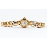 A ladies 18ct gold Lord wristwatch, round silvered dial with baton and number markers, fleur de