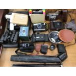 A collection of vintage cameras and equipment including binoculars, cine machine and Screen Beau,