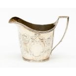 A George III silver helmet shaped cream jug, with chased scrolled decoration, plain cartouche,