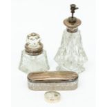 A collection of mid 20th Century silver rimmed perfume bottles, pin dish and silver pill box