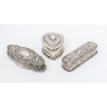 A Victorian heart shaped silver dressing table box, the detachable cover and body profusely chased
