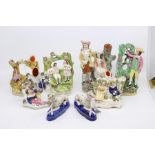 A collection of Staffordshire figure groups and figural spill vases of various scenes, five dpicting