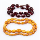 A string of graduated egg yolk butterscotch amber beads, comprising graduated oval beads the largest