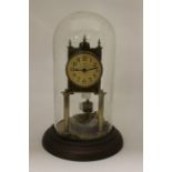 An early 20th Century brass cased anniversary clock, four pillared movement, the dial stamped CB