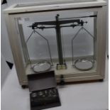 A 1960's Gallenhamp set of scientific scales, fitted in a white painted glazed case, complete with a