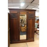 An Edwardian mahogany wardrobe, carved decoration to doors