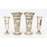 A pair of late Victorian silver vases, flared rim above cylindrical bodies chased with floral and