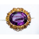A Victorian amethyst and 18ct gold filigree pendant, the oval amethyst, approx 32 x 25mm, claw set