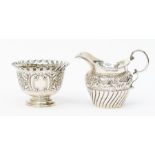 A Victorian silver sugar bowl, pinched wavy border above body profusely chased with scrolls, flowers
