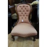 A Victorian walnut ladies chair, with deep buttoned back, upholstered in salmon pink, 89cm high