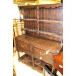 An early 20th Century oak dresser and rack, the base with two drawers, pot board base tier, 163cm