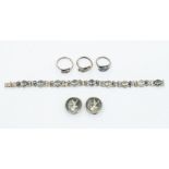 A collection of Siamese silver jewellery, including a bracelet, a pair of clip earrings and three