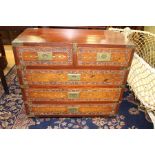 A Chinese hardwood chest of drawers, the drawer fronts carved and inlaid with brass, carrying
