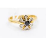A sapphire and diamond 18ct gold ring, comprising a round cut sapphire to the centre with an