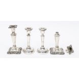 A pair of late Victorian silver candlesticks shaped square bases, plain tapering stems, by James