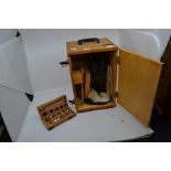 An early to mid 20th Century oak cased set of scales, a small boxed travel set of scales and a