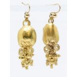 A pair of high carat gold earrings with wirework and granular decoration, possibly Roman origin,