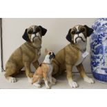 Three Leonardo resin dogs