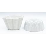 Two Shelley white glazed jelly moulds, variou ssizes, larget measuring 10cms high approx (2)