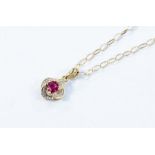 A ruby and diamond flower cluster 9ct gold pendant, claw set ruby to the centre of approx 0.25ct, on