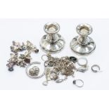 A collection of silver and white metal jewellery to include a charm bracelet with various charms