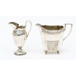 A Victorian silver milk jug, engraved leaf border with central lower gadroon section on four