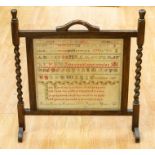 A Victorian sampler by Lucy Clarke of Codnor 1874 within a fire screen