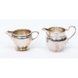 A George V plain silver cream jug, by Adie Brothers, Birmingham, 1914 and another similar rope twist