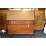 An Edwardian mahogany bureau, with parquetry stringing, the fall front opening to reveal a fitted
