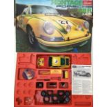 Schuco: A boxed Schuco Montage Porsche 911R Rallye. Ref 225 294. 1:16 scale kit in assembled