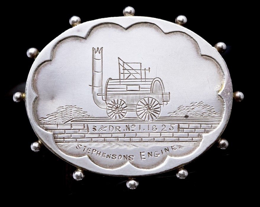 Railwayana Interest: A silver hallmarked, oval brooch, engraved with Stephenson's Engine, 'S & D R