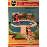 Sindy: A Sindy Swimming Pool, complete and in very good original box. Along with Garden Furniture