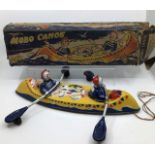 Tinplate: A Mobo Canoe, 1950’s made by D.Sebel & Co. Ltd. tinplate pull along canoe on wheels.