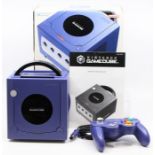 Nintendo GameCube: A boxed Nintendo GameCube purple console, appears complete with instructions