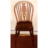 An early 20th century elm wheelback High Wycombe edition of the Windsor chair. 92cm H x37cm W x 39cm