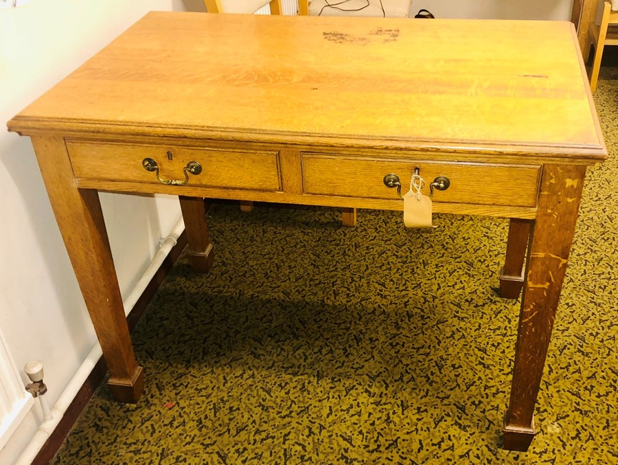 A late Victorian light oak writing desk, circa 1900, slight oversailing top above two frieze drawers